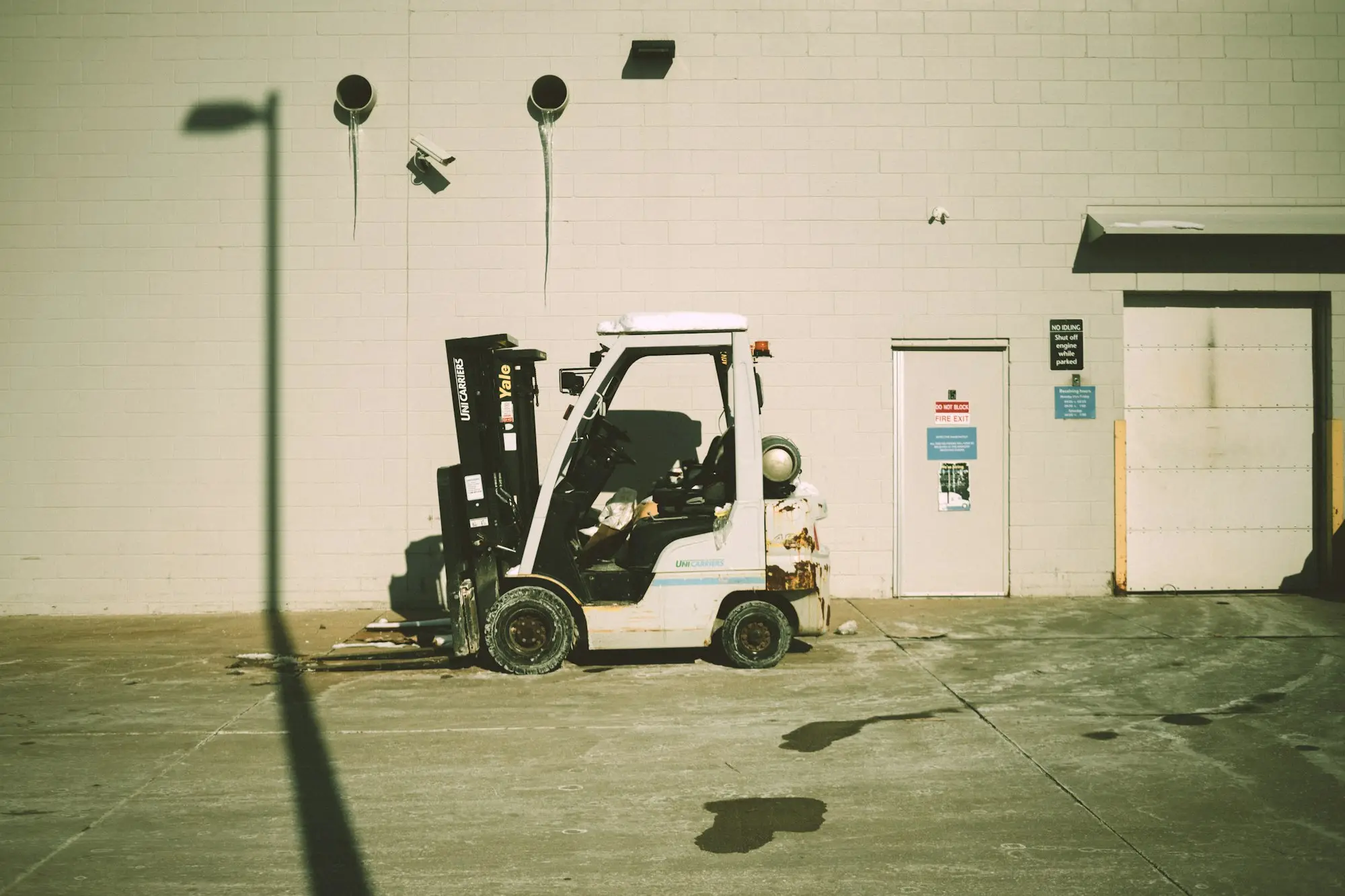 Forklift parked outside a warehouse used by a wholesale distributor